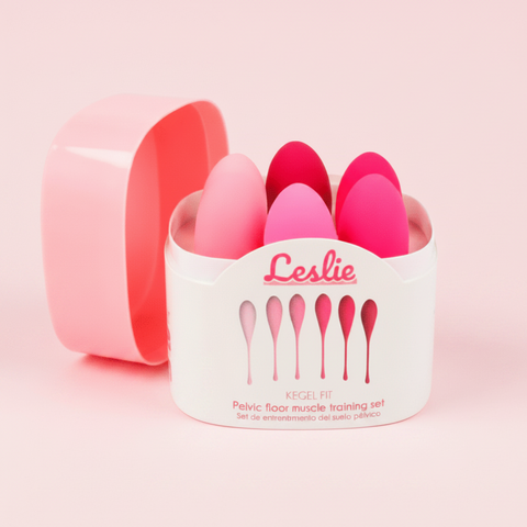 Pelvic floor muscle training set with pink and red Kegel fit tools in a pink and white container labeled 'Leslie'.