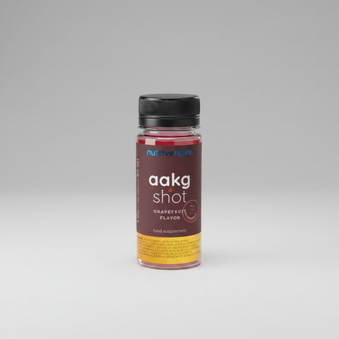Black supplement bottle labeled 'aakg shot' on a white background